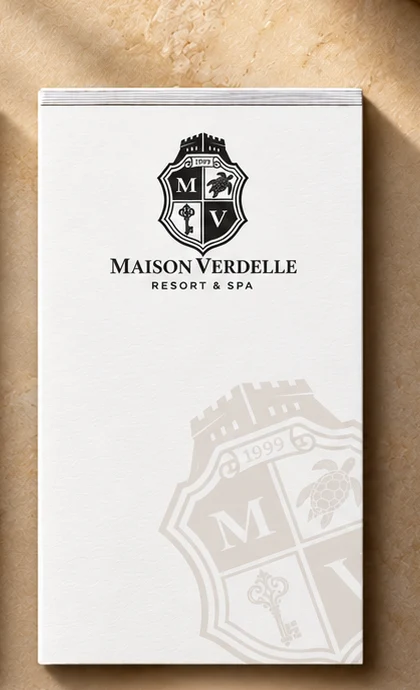 3.5 x 5.5 inch compact hotel notepad with logo beside a bedside phone