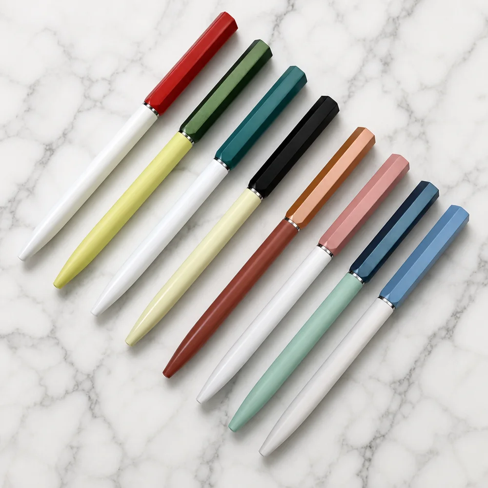 Two-tone twist pen with faceted caps in red, green, teal, black, orange, pink and blue
